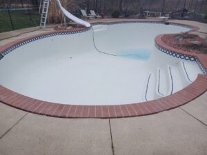 Image of a recently resurfaced pool in Livonia, MI, showcasing a clean and modern look, completed by Downriver Pool Service