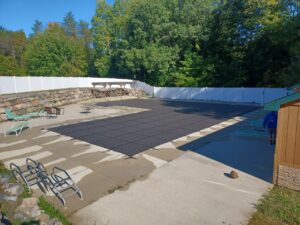 Image of a pool safety cover being installed by a professional technician from Downriver Pool Service in Canton, MI